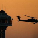 The sun sets as an U.S. Apache helicopter takes off from the Green Zone to patrol over Baghdad